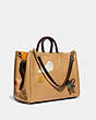 COACH®,ROGUE 39 WITH CREATURE PATCHES,Pebble Leather/Smooth Leather,X-Large,Brass/Light Tan Multi,Angle View