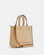 COACH®,COACH X JENNIFER LOPEZ DEMPSEY TOTE 22 WITH NYC SKYLINE,Leather,Medium,Gold/Cream,Angle View