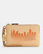 COACH®,COACH X JENNIFER LOPEZ CORNER ZIP WRISTLET WITH NYC SKYLINE,Mini,Gold/Cream,Front View