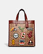 COACH®,FIELD TOTE IN SIGNATURE CANVAS WITH PATCHES,Signature Coated Canvas/Smooth Leather,Medium,Brass/Tan/Rust,Front View