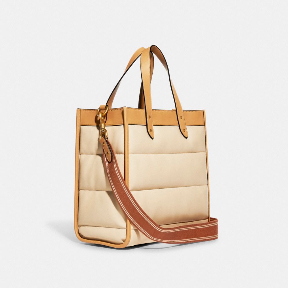 COACH®,FIELD TOTE WITH COLORBLOCK QUILTING AND COACH BADGE,Smooth Leather,Medium,Brass/Ivory Multi,Angle View