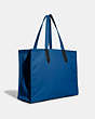 COACH®,COACH X MICHAEL B. JORDAN CANVAS TOTE 42 WITH MUMMIFIED REXY,Recycled Canvas/Recycled Leather,X-Large,JI/Blue,Angle View