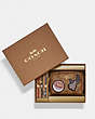 COACH®,BOXED MINI BOXY COSMETIC CASE AND HAIR TIES SET IN SIGNATURE CANVAS WITH DISCO PATCHES,Mini,Gold/Khaki Multi,Front View