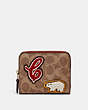 COACH®,BILLFOLD WALLET IN SIGNATURE CANVAS WITH PATCHES,Mini,Brass/Tan/Rust,Front View