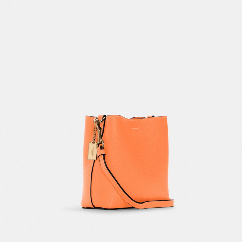 COACH®,MINI TOWN BUCKET BAG,Pebbled Leather,Small,Gold/Candied Orange,Angle View