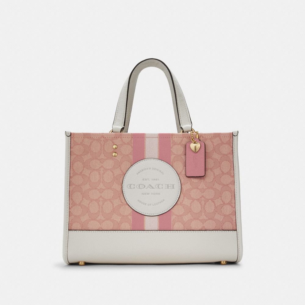 Coach signature handbag with pink and white stripe for Sale in