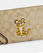 COACH®,LARGE CORNER ZIP WRISTLET IN SIGNATURE CANVAS WITH TIGER,Leather,Mini,Gold/Light Khaki Chalk,Detail View