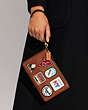 COACH®,SMALL WRISTLET WITH PATCHES,Brass/1941 Saddle,Detail View