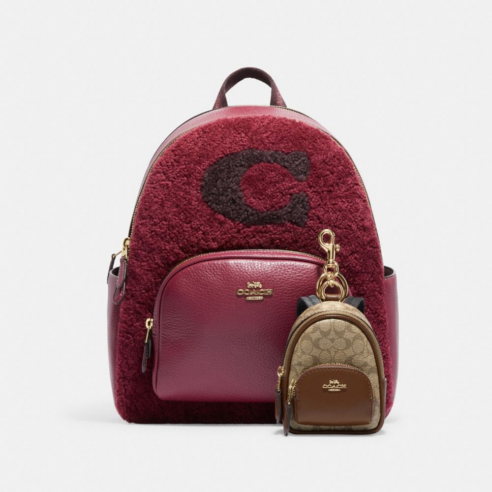 COACH®,MINI COURT BACKPACK BAG CHARM IN SIGNATURE CANVAS,Mini,Gold/Khaki Saddle,Angle View