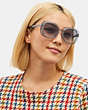 COACH®,EMBEDDED SIGNATURE ROUND SUNGLASSES,Transparent Blue,Angle View