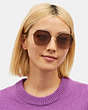 COACH®,METAL HEXAGON SUNGLASSES,Brown Pink Gradient,Angle View