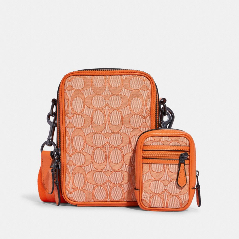 COACH®,MICRO NORTH/SOUTH HYBRID KEY FOB IN SIGNATURE JACQUARD,Mini,Gunmetal/Candied Orange,Angle View