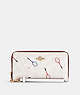 COACH®,LONG ZIP AROUND WALLET IN SIGNATURE CANVAS WITH RACQUET PRINT,Leather,Mini,Gold/Chalk Multi,Front View