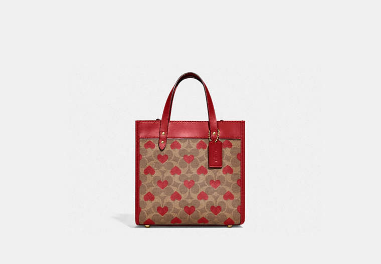 COACH®,FIELD TOTE 22 IN SIGNATURE CANVAS WITH HEART PRINT,Signature Coated Canvas/Smooth Leather,Medium,Brass/Tan Red Apple,Front View