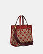 COACH®,FIELD TOTE 22 IN SIGNATURE CANVAS WITH HEART PRINT,Signature Coated Canvas/Smooth Leather,Medium,Brass/Tan Red Apple,Angle View