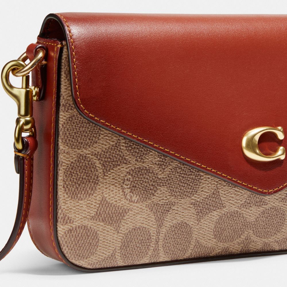 Coach envelope clutch in leather and coated canvas with logo