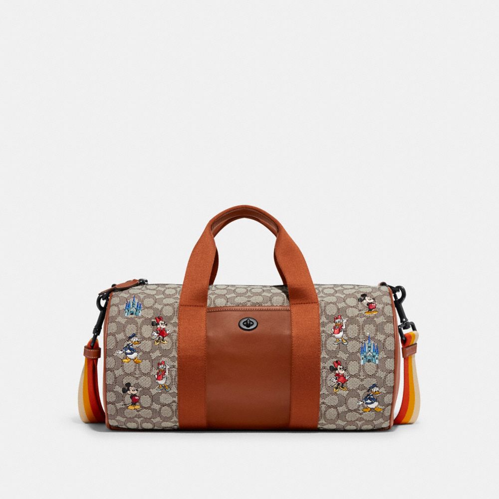 Duffle Disney X Coach en textile jacquard signature avec broderie de Mickey Mouse et ses amis