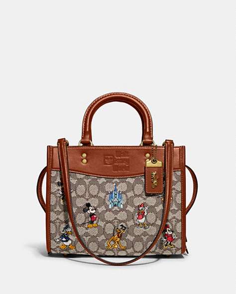 COACH®,DISNEY X COACH ROGUE 25 IN SIGNATURE TEXTILE JACQUARD WITH MICKEY MOUSE AND FRIENDS EMBROIDERY,Signature ...,Brass/Cocoa Burnished Amber Multi,Front View