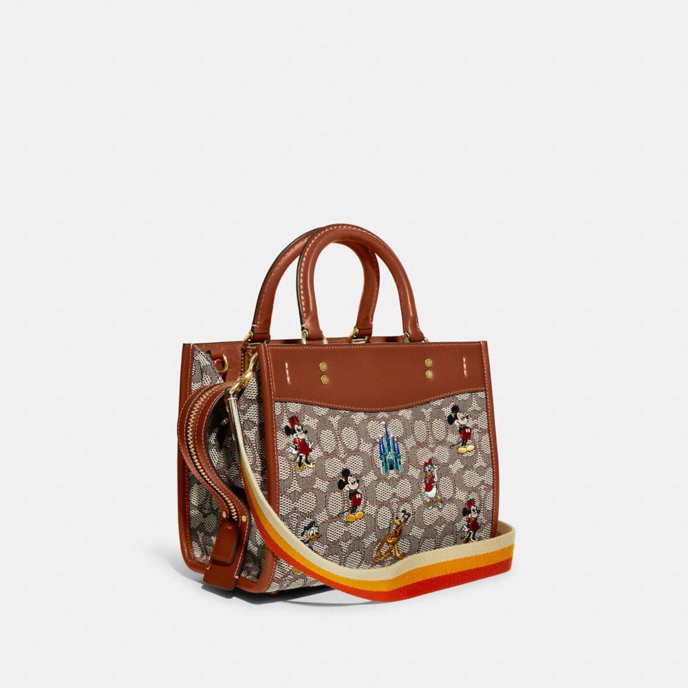 COACH®,DISNEY X COACH ROGUE BAG 25 IN SIGNATURE TEXTILE JACQUARD WITH MICKEY MOUSE AND FRIENDS EMBROIDERY,Signat...,Brass/Cocoa Burnished Amber Multi,Angle View