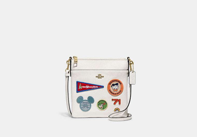 COACH®,DISNEY X COACH KITT MESSENGER CROSSBODY WITH PATCHES,Polished Pebble Leather,Small,Brass/Chalk,Front View