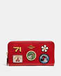 COACH®,DISNEY X COACH ACCORDION ZIP WALLET WITH PATCHES,Polished Pebble Leather,Mini,Brass/Electric Red,Front View