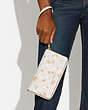 COACH®,LONG ZIP AROUND WALLET IN SIGNATURE CANVAS WITH MYSTICAL FLORAL PRINT,Mini,Gold/Chalk Multi,Detail View