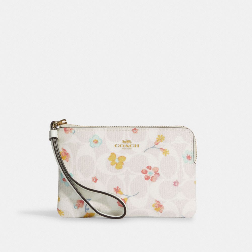 Corner zip wristlet in signature canvas with butterfly hot sale print