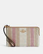 COACH®,LARGE CORNER ZIP WRISTLET IN SIGNATURE JACQUARD WITH STRIPES,Mini,Gold/Taffy Multi,Front View
