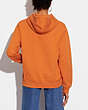 COACH®,HORSE AND CARRIAGE HOODIE IN ORGANIC COTTON,Organic Cotton,Papaya,Scale View