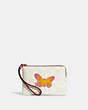 COACH®,CORNER ZIP WRISTLET IN SIGNATURE CANVAS WITH BUTTERFLY,Jacquard,Mini,Gold/Chalk/Taffy Multi,Front View