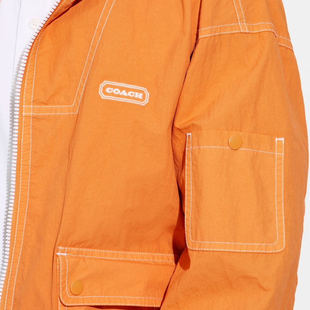COACH®,Lightweight Windbreaker,Polyamide,Utility Jacket,Drawstring,Stitching,Casual,Orange,Detail View