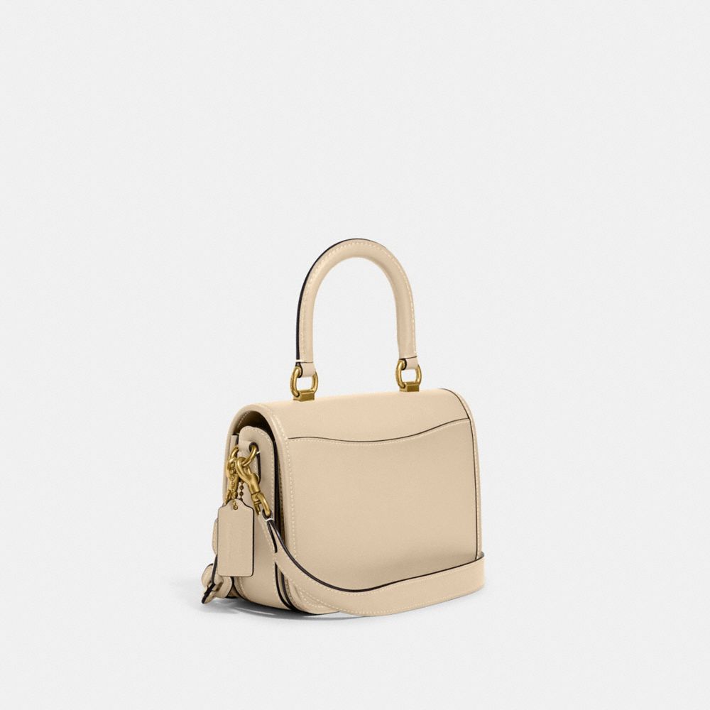 COACH®,COACH X TOM WESSELMANN ROGUE TOP HANDLE BAG,Glovetan Leather,Mini,Brass/Ivory,Angle View