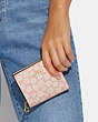 COACH®,SNAP WALLET WITH GRAPHIC DITSY FLORAL PRINT,Gold/Pink Multi,Detail View
