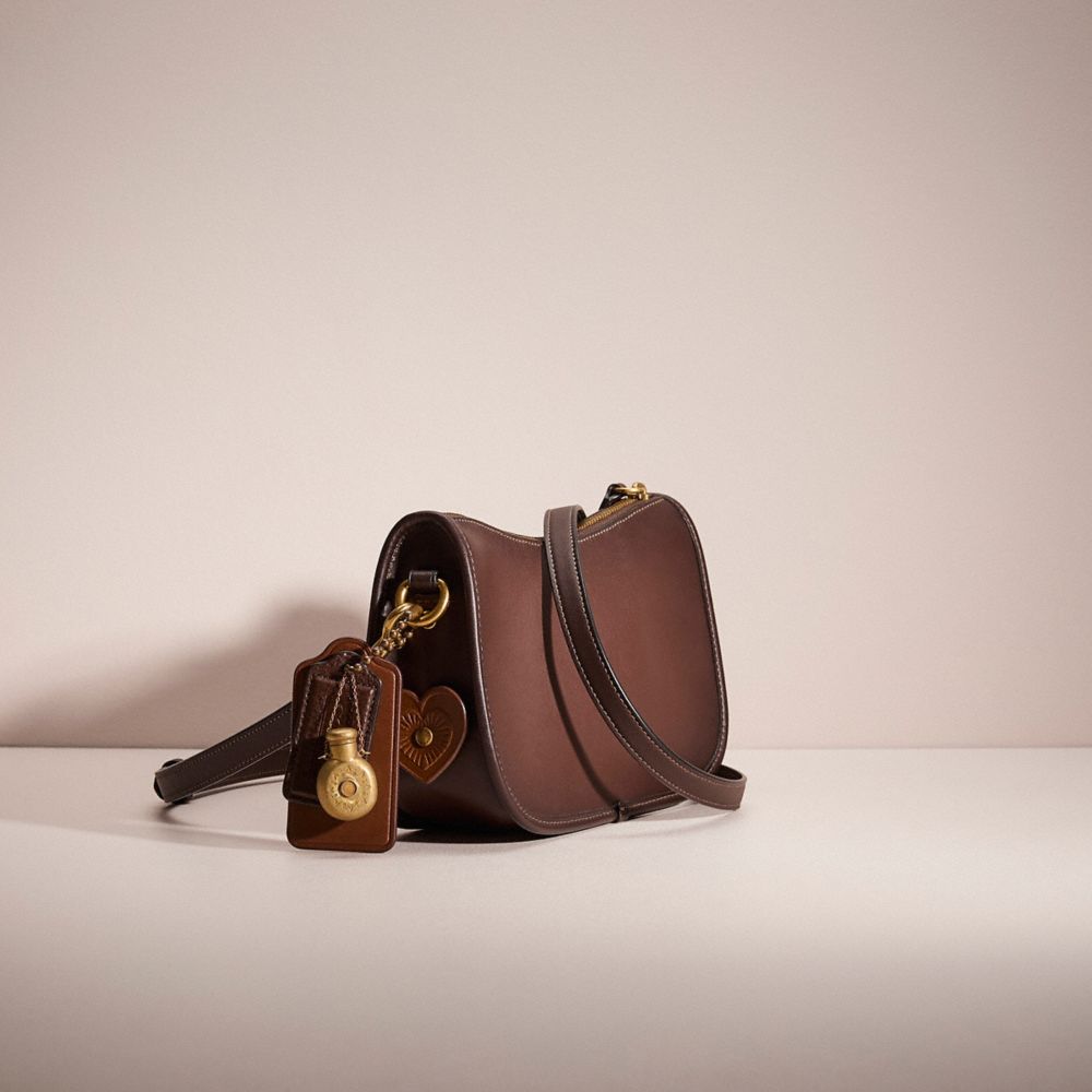 COACH®,Upcrafted Swinger Bag,Leather,Shoulder Bag,Braided,Applique,Metal,Studded,Logo,Gold Metal,Day Party,Brown,Angle View