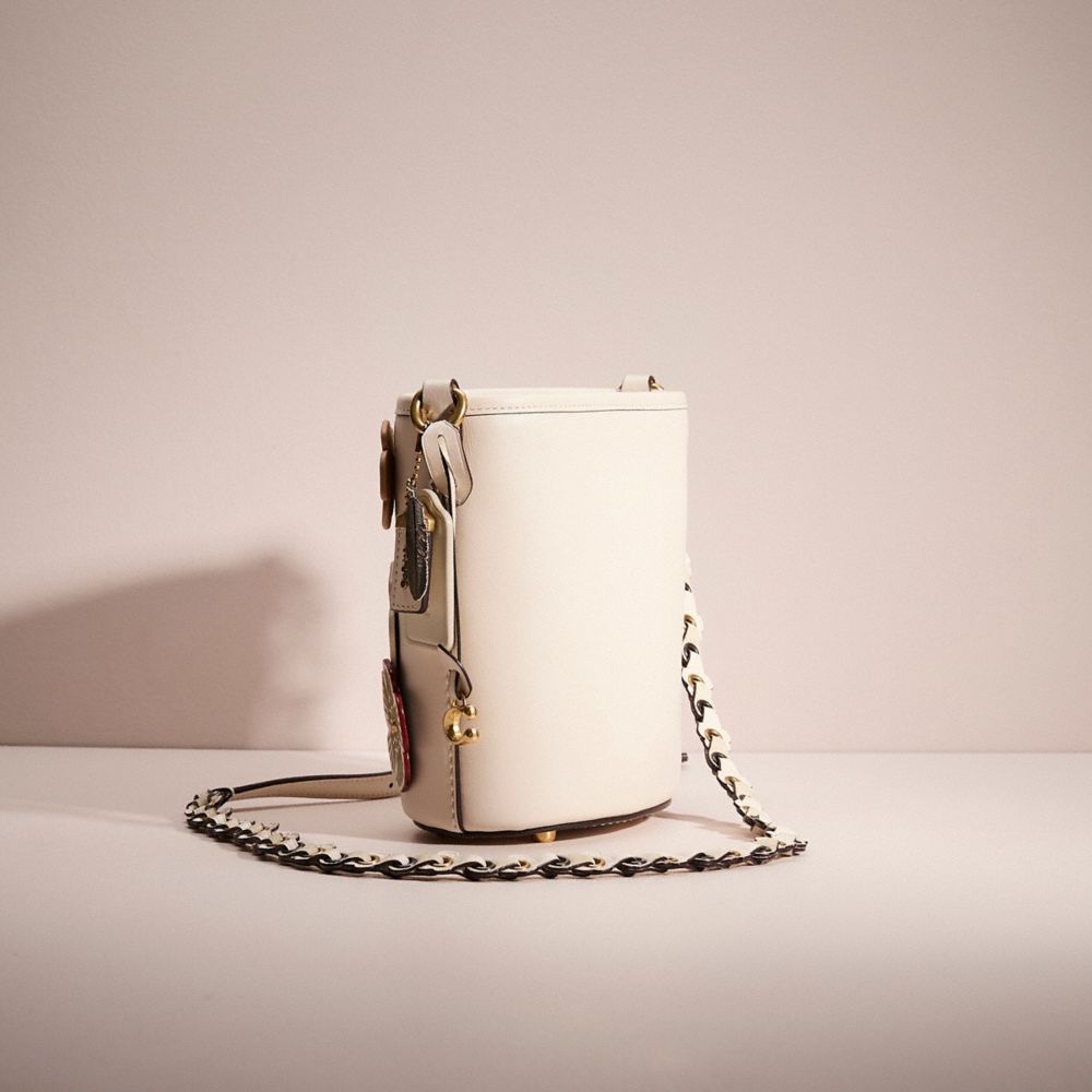 COACH®,Upcrafted Dakota Bucket Bag 16,Leather,Bucket,Applique,Logo,Metal,Chain Detail,Gold Metal,Day Party,Cream,Angle View