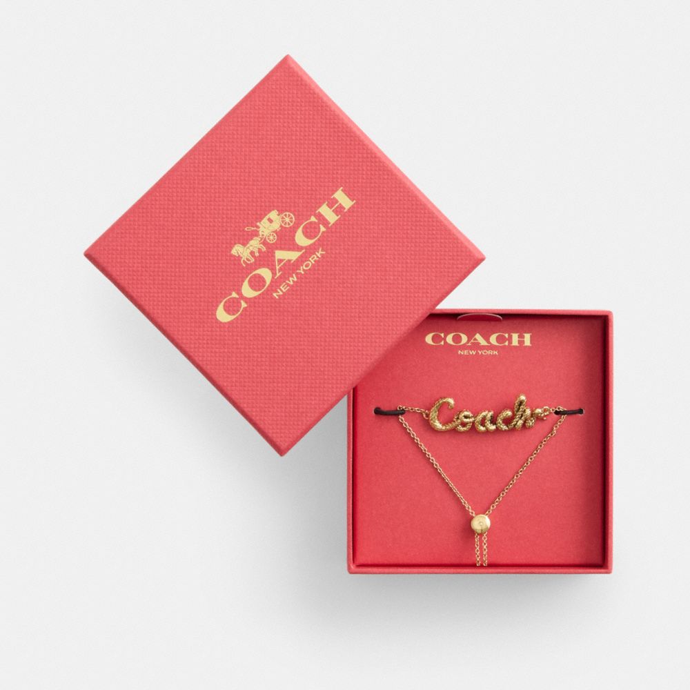 COACH®,New Year Coach Snake Script Slider Bracelet,Cubic Zirconia,Crystal,3D Embellishment,Gem Embellishment,Logo,Novelty ...,Maroon,Front View