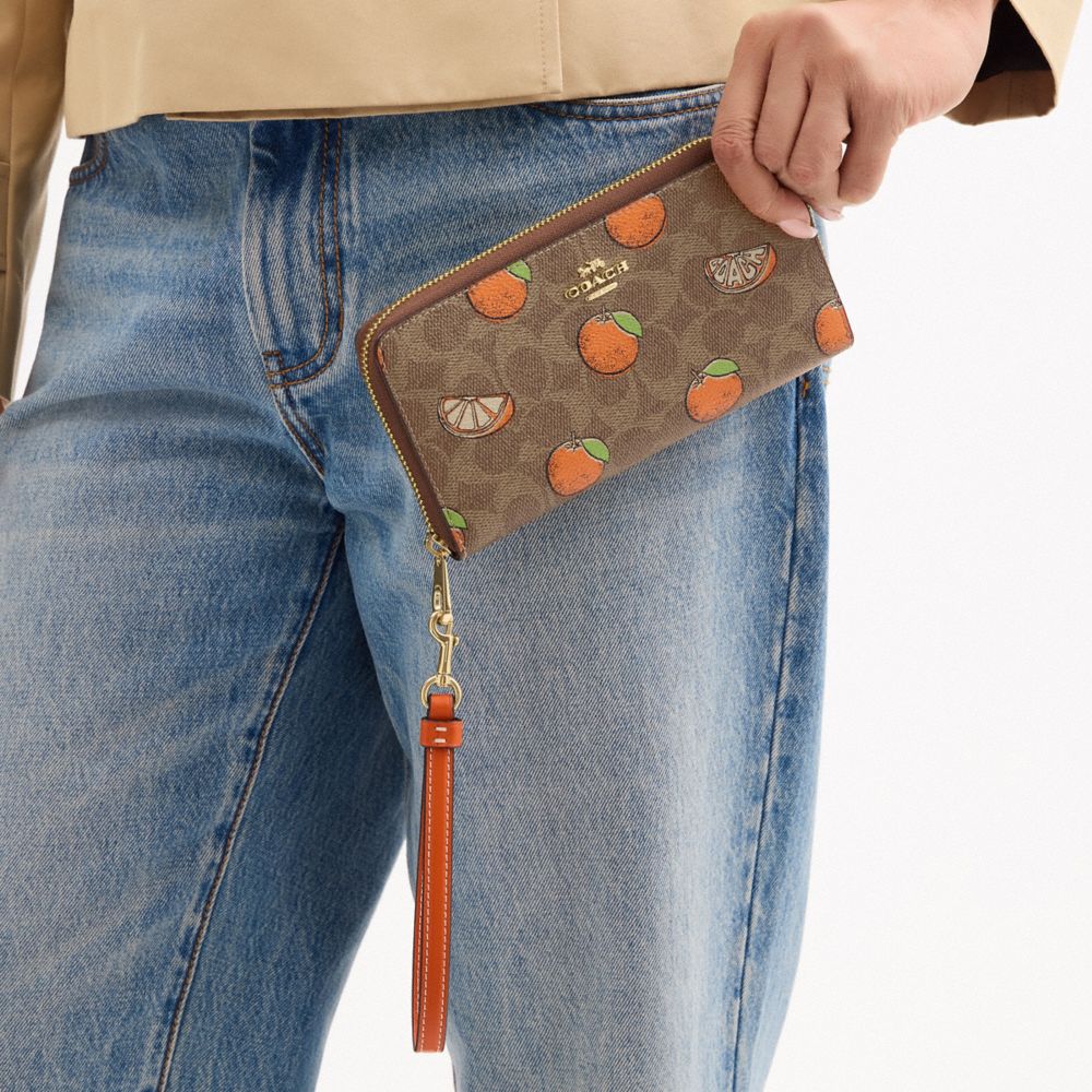 COACH®,Long Zip Around Wallet In Signature Canvas With Orange Print,,Detail View