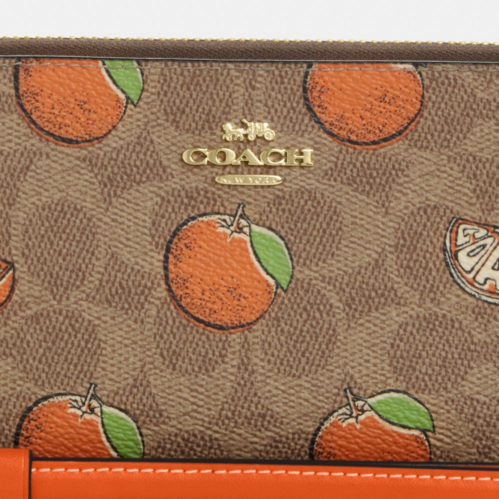 COACH®,Long Zip Around Wallet In Signature Canvas With Orange Print,,Closer View