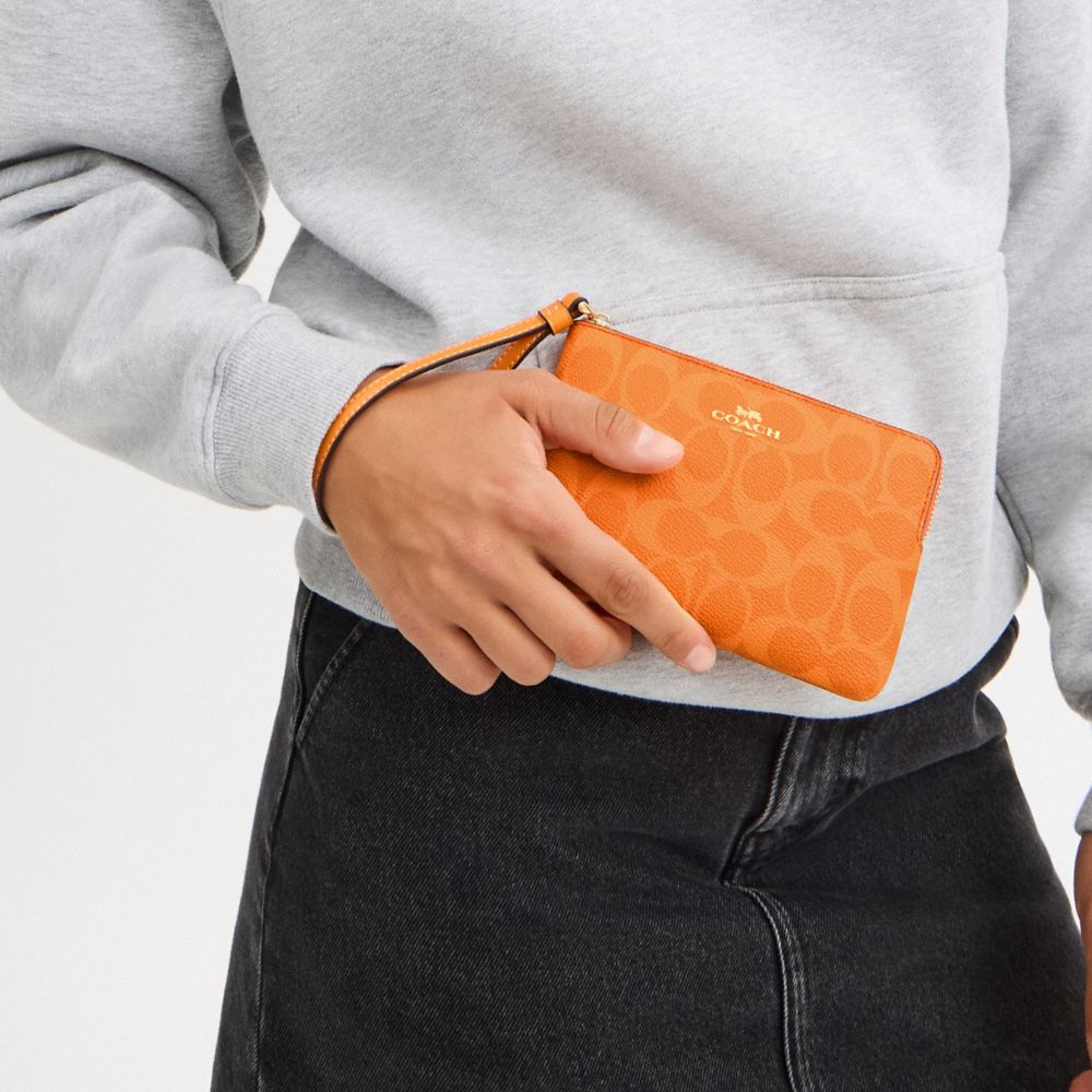 COACH®,Corner Zip Wristlet In Signature Canvas,Wristlet,Pouch,Plastic,Casual,Orange,Detail View