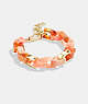 COACH®,CHUNKY SIGNATURE LINK BRACELET,Brass,Gold/Coral Multi,Front View