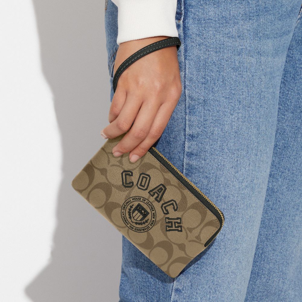 COACH®,CORNER ZIP WRISTLET IN SIGNATURE CANVAS WITH VARSITY MOTIF,Signature Canvas,Mini,Gold/Khaki/Amazon Green,Detail View