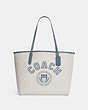 COACH®,CITY TOTE IN SIGNATURE CANVAS WITH VARSITY MOTIF,Signature Coated Canvas,Large,Silver/Chalk/Indigo,Front View