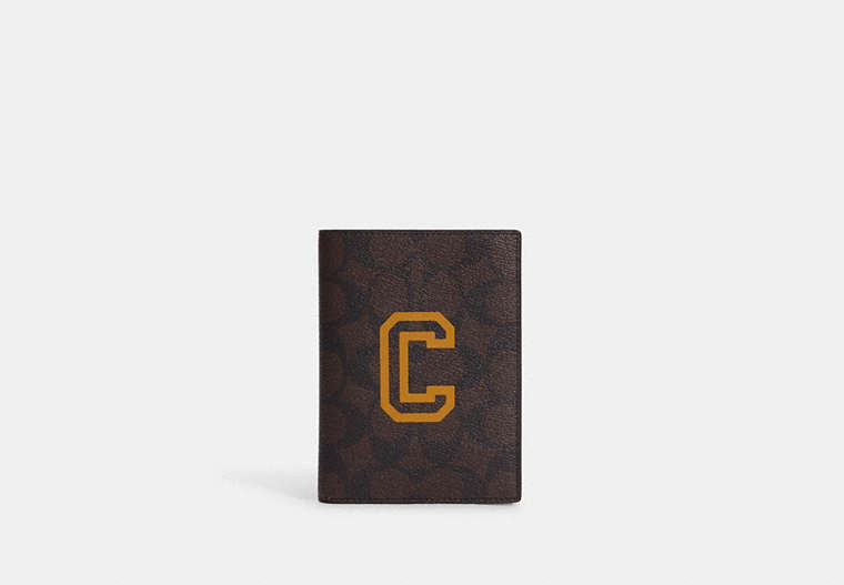 COACH®,PASSPORT CASE IN SIGNATURE CANVAS WITH VARSITY MOTIF,Mini,Black Antique Nickel/Mahogany/Buttercup,Front View