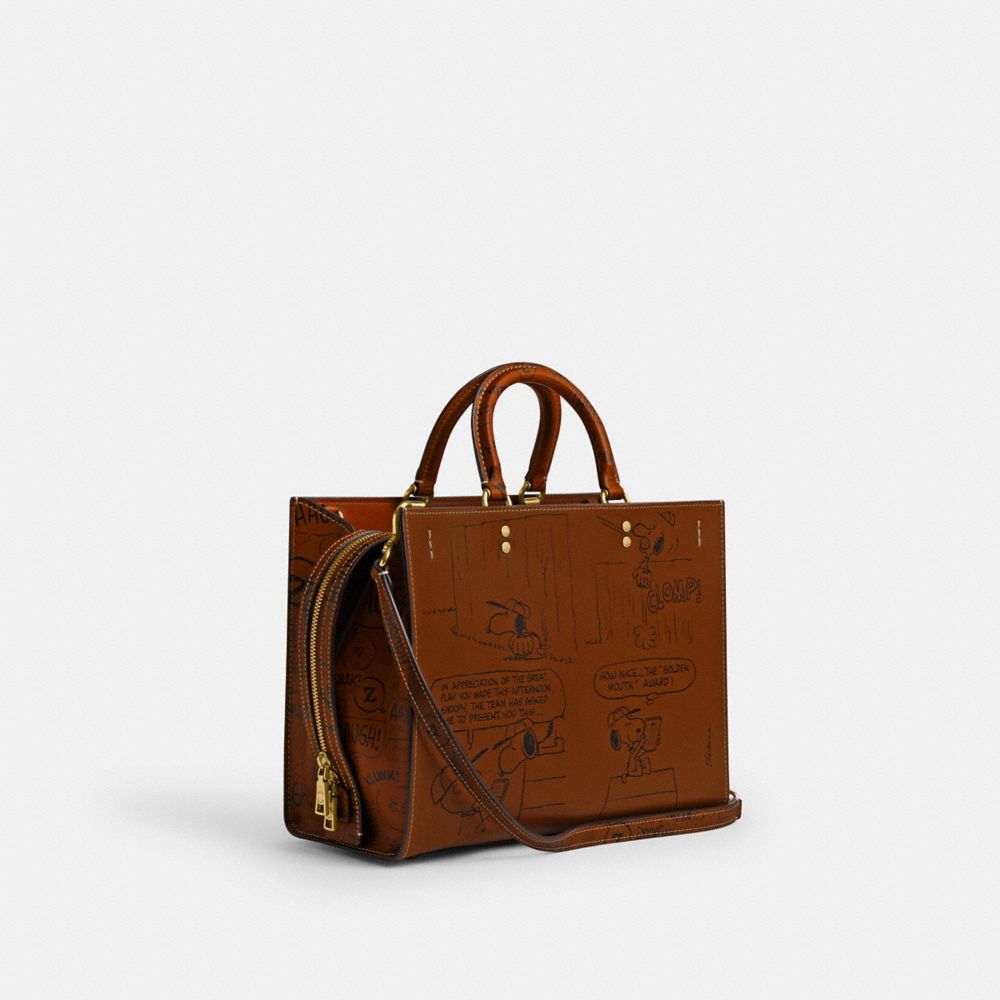 COACH®,Coach X Peanuts Rogue Bag With Newspaper Print,,Angle View