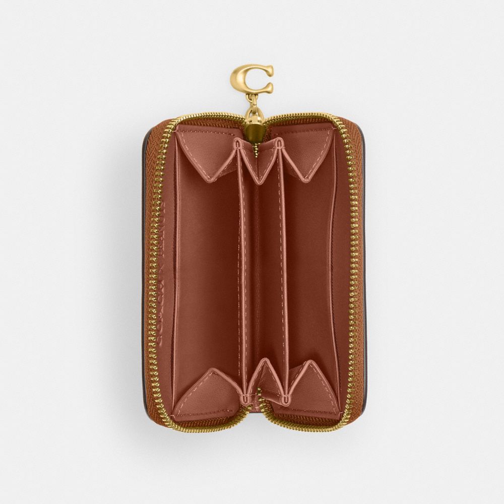 COACH®,【COACH X PEANUTS】スモール ジップ アラウンド カード ケース・ニュースペーパー プリント,カードケース/定期入れ/名刺入れ,ﾌﾞﾗｽ/ﾍｰｾﾞﾙﾅｯﾂ