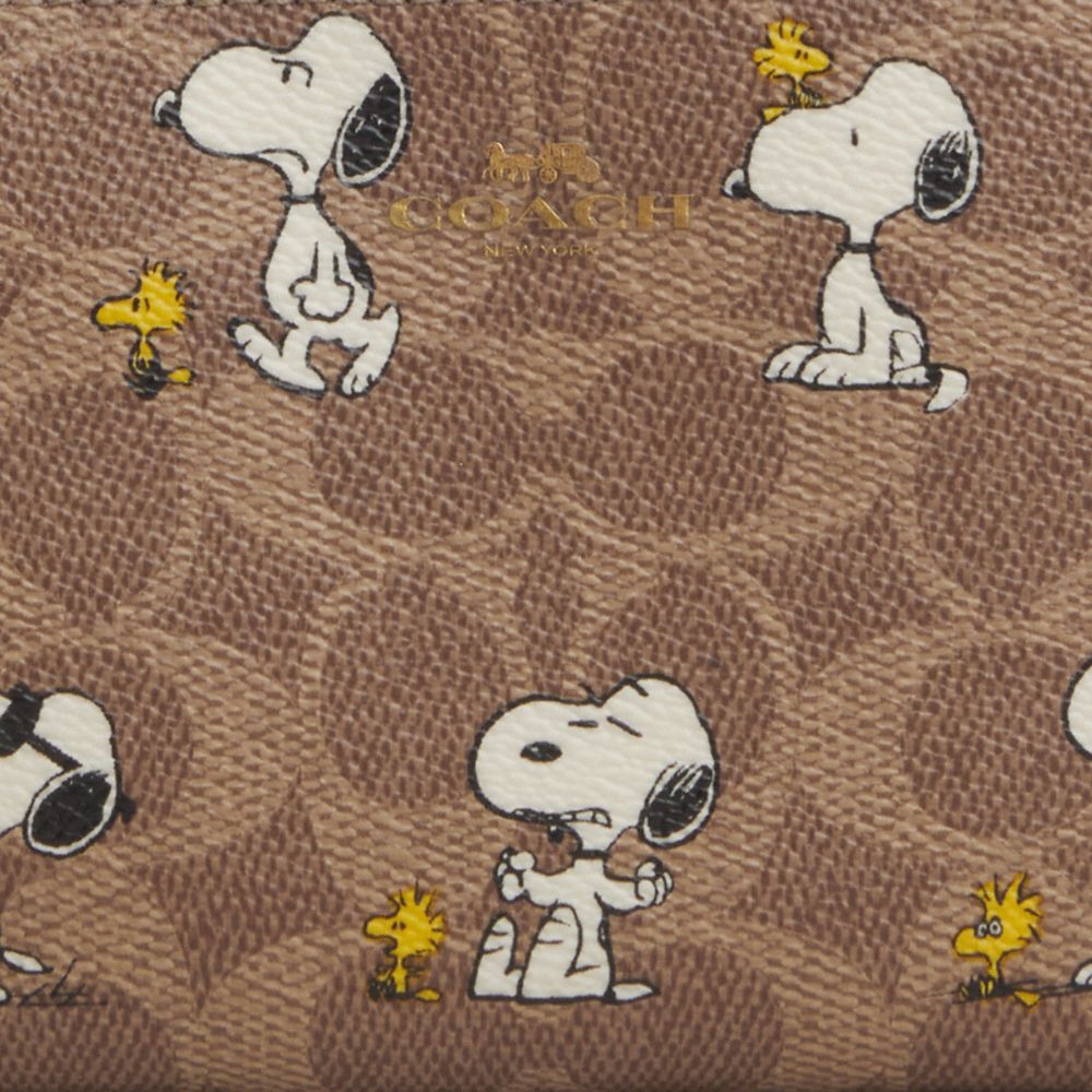 COACH®,Coach X Peanuts Corner Zip Wristlet In Signature Canvas With Snoopy Print,,Closer View