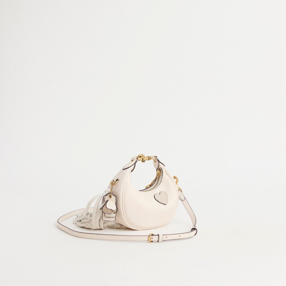 COACH®,Upcrafted Jonie Bag,Leather,Crossbody,Logo,Metal,Chain Detail,Fringe,Compact,Brass,Day Party,Cream,Angle View