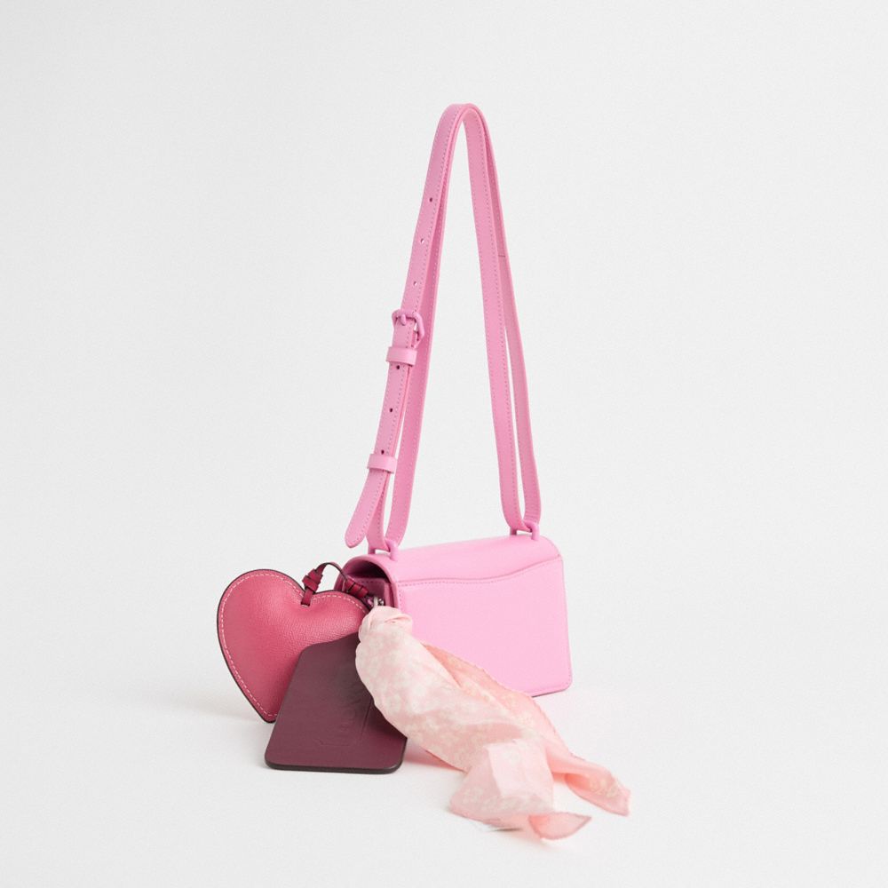 COACH®,Upcrafted Bandit Crossbody Bag,Calfskin Leather,Crossbody,Logo,Metal,Applique,Heart Embellishment,Adjustable,Vegan,...,Pink,Angle View