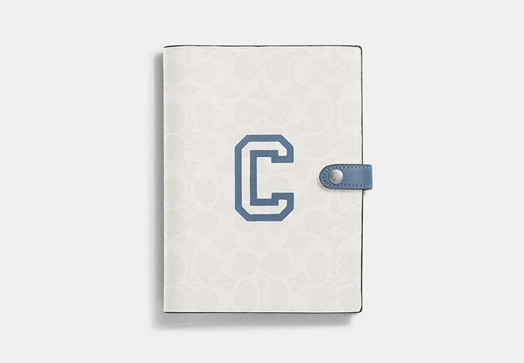 COACH®,NOTEBOOK IN SIGNATURE CANVAS WITH VARSITY MOTIF,Silver/Chalk/Indigo,Front View