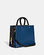 COACH®,ROGUE BAG IN COLORBLOCK WITH RIVETS,Glovetanned Leather,Large,Brass/True Blue Multi,Angle View